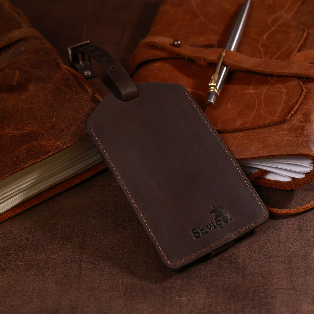 Vintage tag on a suitcase made of genuine leather shvigel 16555 brown
